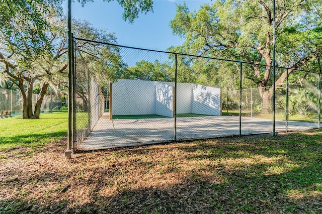 view of basketball court featuring a yard