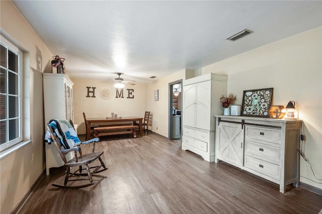 living area featuring ceiling fan and hardwood / wood-style floors