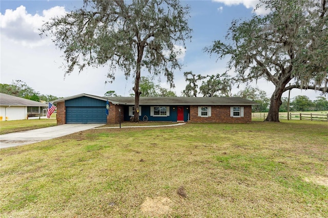 ranch-style home with a garage and a front lawn