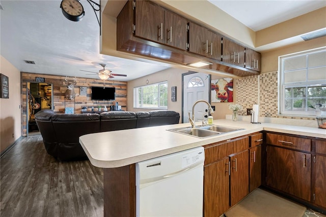 kitchen with dishwasher, sink, ceiling fan, kitchen peninsula, and dark wood-type flooring