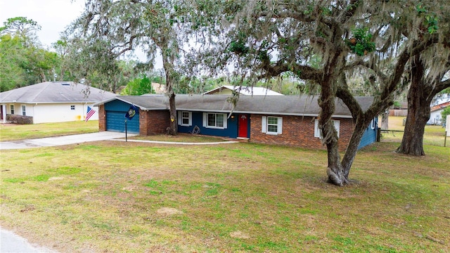 single story home featuring a garage, driveway, a front lawn, and brick siding