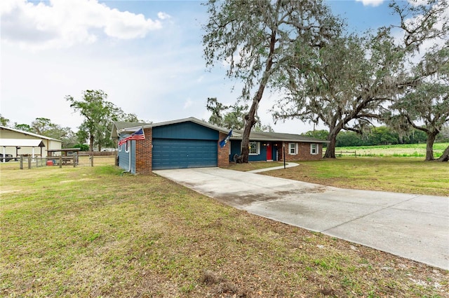 ranch-style house featuring a garage, concrete driveway, brick siding, and a front yard