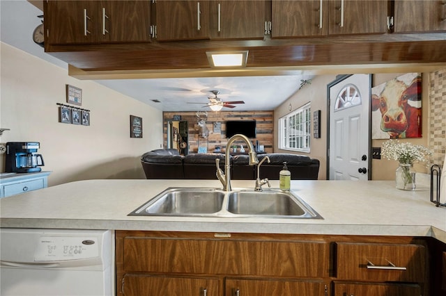 kitchen with a ceiling fan, open floor plan, white dishwasher, light countertops, and a sink