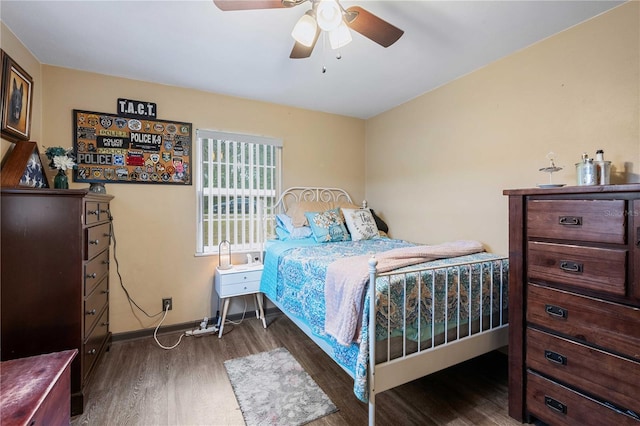 bedroom featuring ceiling fan, baseboards, and wood finished floors