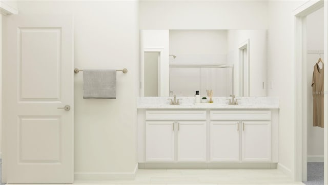 bathroom featuring vanity and a shower with shower door