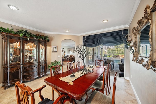 tiled dining space featuring ornamental molding