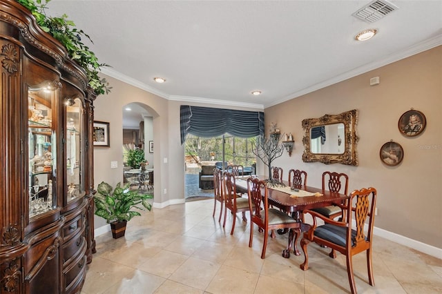 dining space featuring light tile patterned floors and crown molding