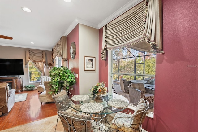 tiled dining space featuring crown molding and plenty of natural light