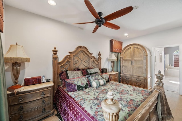 carpeted bedroom with ensuite bathroom and ceiling fan