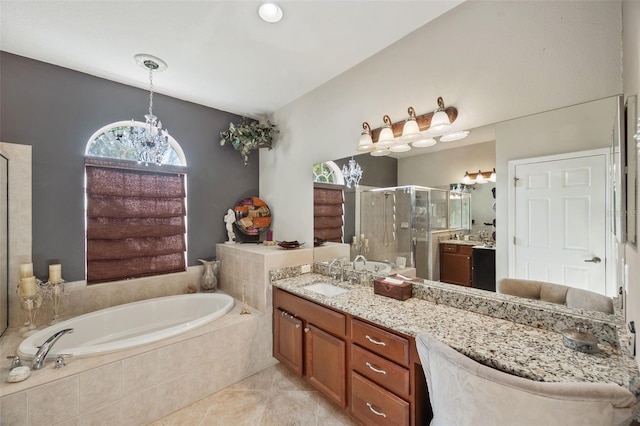 bathroom featuring shower with separate bathtub, a notable chandelier, tile patterned floors, and vanity