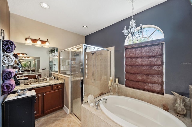 bathroom with a notable chandelier, tile patterned flooring, plus walk in shower, and vanity