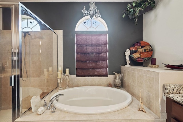 bathroom with vanity and shower with separate bathtub