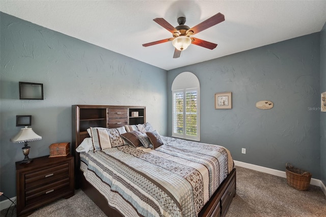 bedroom featuring ceiling fan and carpet