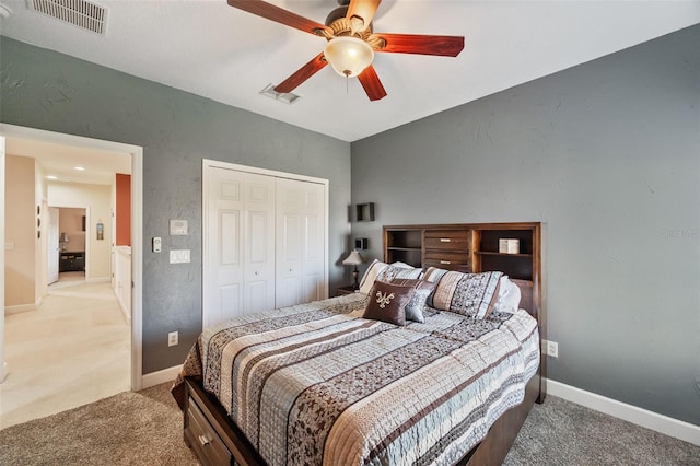 bedroom with ceiling fan, a closet, and carpet flooring