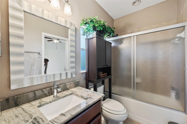 full bathroom with ceiling fan, enclosed tub / shower combo, vanity, and toilet