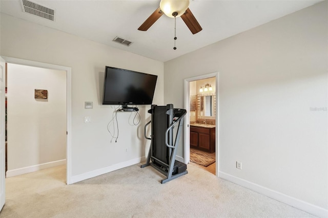 workout area featuring ceiling fan, light carpet, and sink