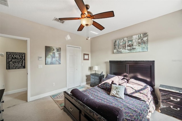 carpeted bedroom with ceiling fan and a closet