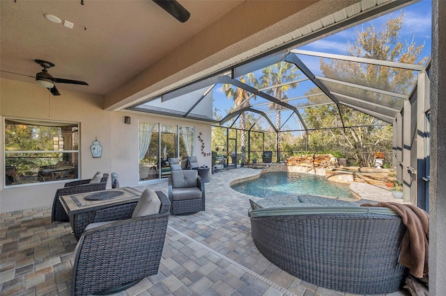 view of patio / terrace featuring a lanai, ceiling fan, and an outdoor living space