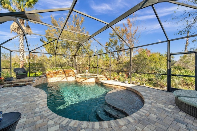 view of swimming pool featuring a patio, glass enclosure, and an in ground hot tub