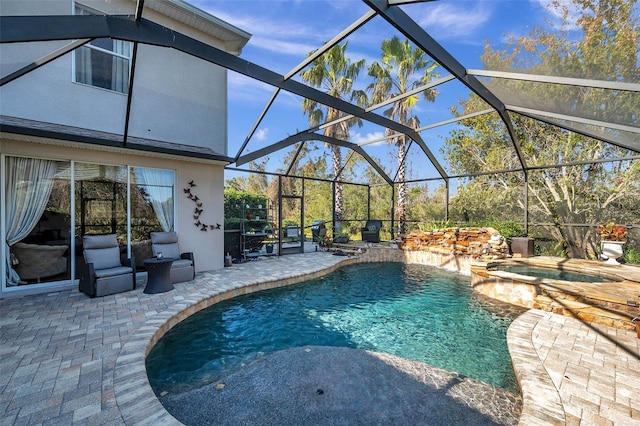 view of swimming pool with an in ground hot tub, glass enclosure, and a patio