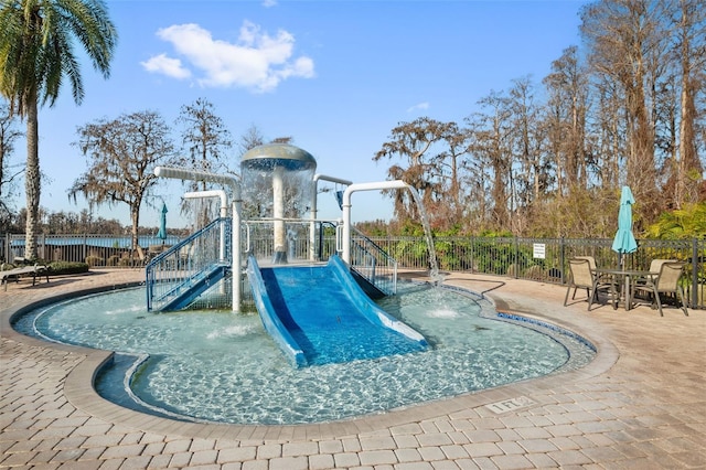 view of swimming pool featuring a playground