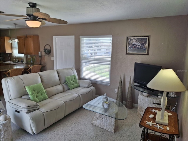 living room with sink and ceiling fan