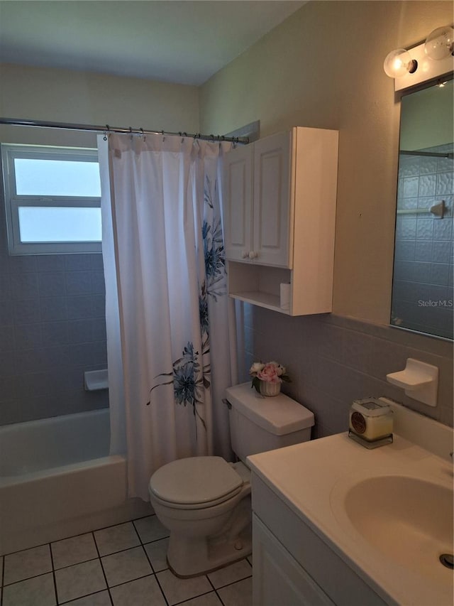 full bathroom with tile walls, tile patterned flooring, vanity, toilet, and shower / bath combo with shower curtain