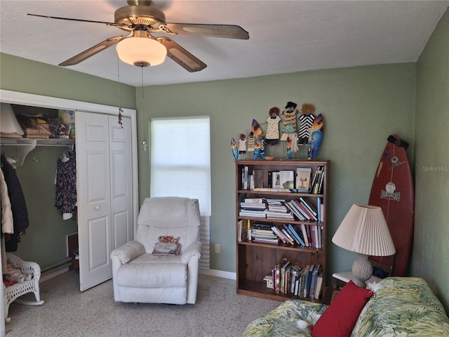 living area featuring ceiling fan