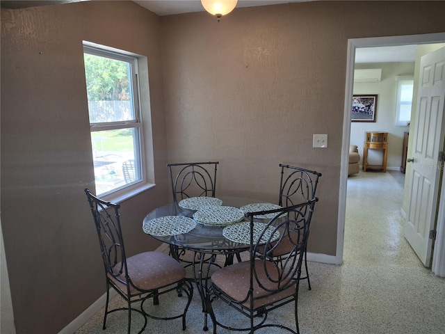 dining room featuring a wall mounted air conditioner