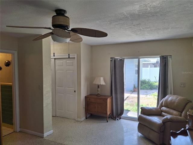 sitting room featuring ceiling fan and a textured ceiling