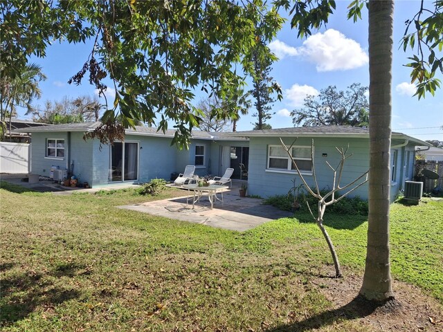 back of house with a lawn, cooling unit, and a patio area