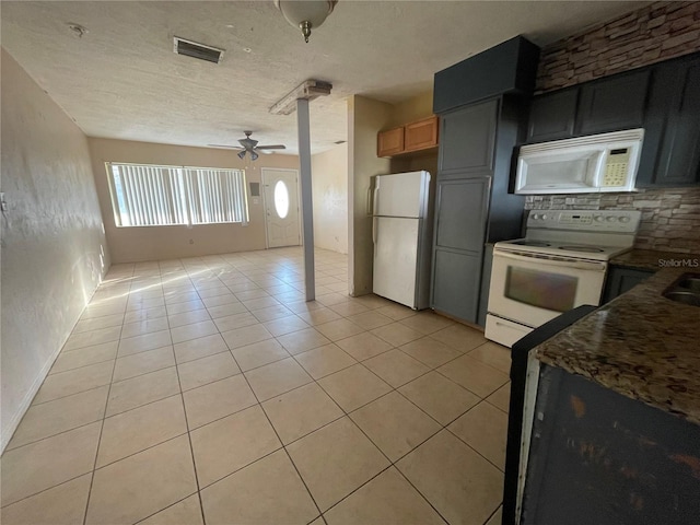 kitchen featuring ceiling fan, white appliances, a textured ceiling, and light tile patterned floors