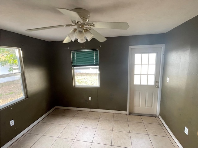 interior space featuring light tile patterned flooring, a wealth of natural light, and ceiling fan