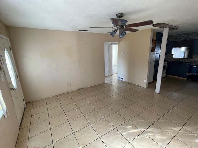 interior space with ceiling fan