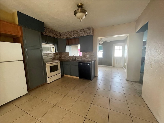 kitchen featuring light tile patterned flooring, white appliances, sink, and decorative backsplash