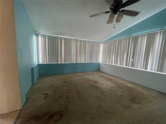 carpeted spare room with lofted ceiling and ceiling fan