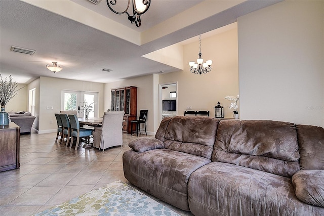 living room featuring light tile patterned floors and a notable chandelier