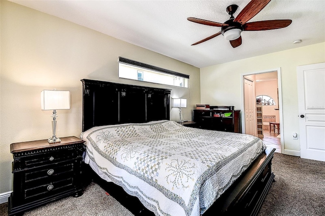 carpeted bedroom featuring ceiling fan and ensuite bath