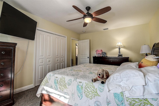 carpeted bedroom featuring ceiling fan and a closet