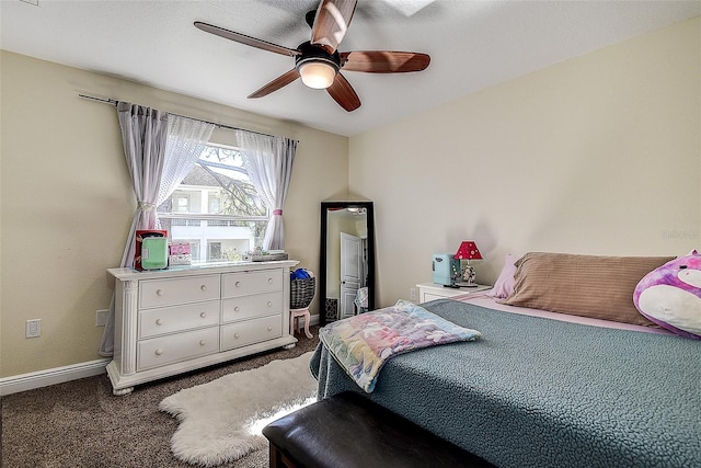 bedroom with ceiling fan and dark colored carpet