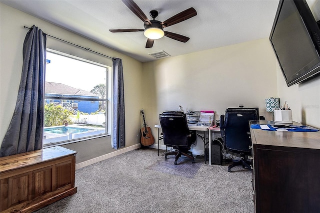 carpeted office space with ceiling fan