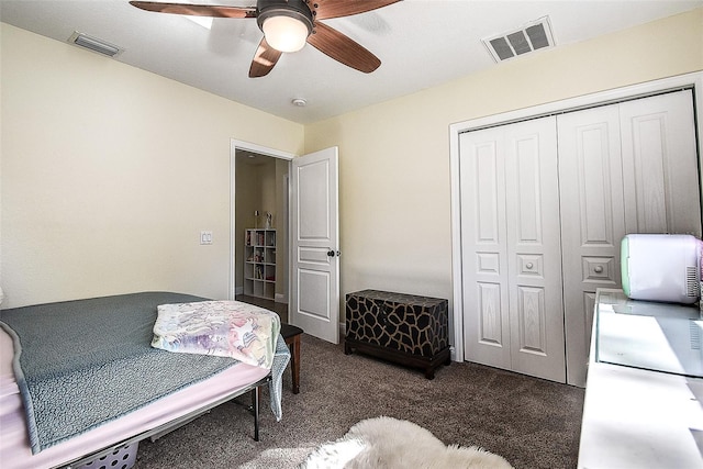 carpeted bedroom featuring ceiling fan and a closet