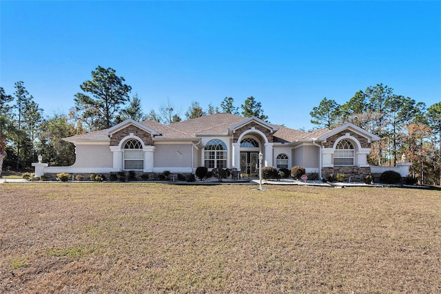 ranch-style home with a front lawn