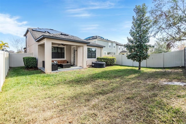 rear view of property with an outdoor hangout area, a patio area, ceiling fan, and a lawn