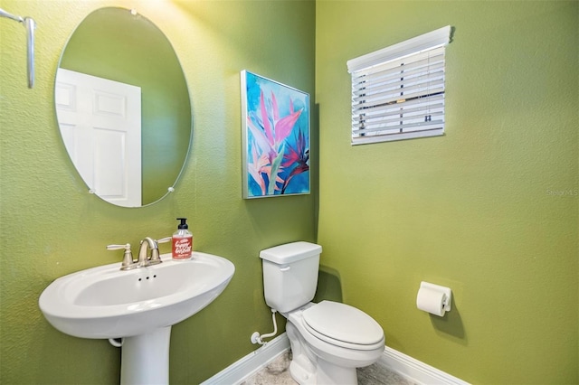 bathroom featuring toilet and sink