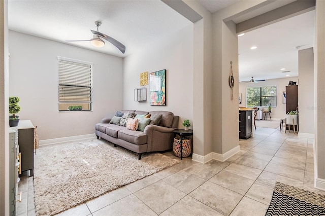 living room featuring light tile patterned flooring and ceiling fan