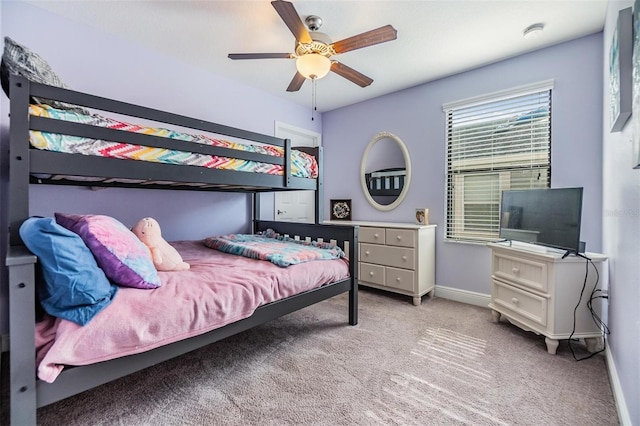 bedroom with light carpet and ceiling fan