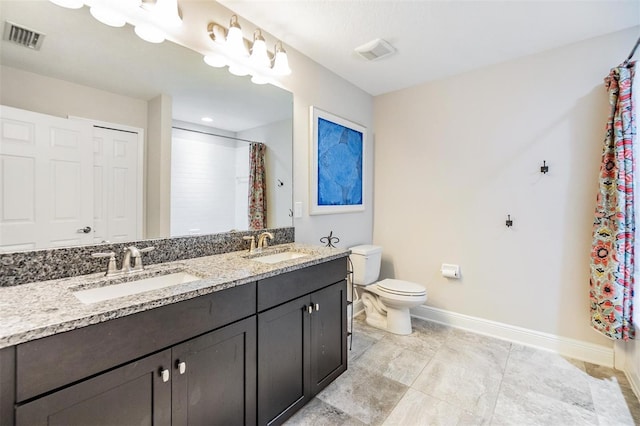 bathroom with toilet, curtained shower, and vanity