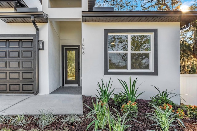 doorway to property with a garage