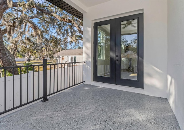 view of exterior entry featuring french doors and a balcony